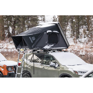 view of ikamper skycamp 3.0 mini on top of SUV, winter camping in the snow